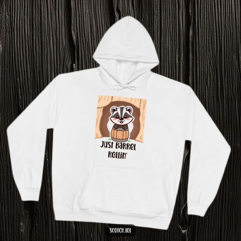 Funny Hoodie showcasing a happy badger peeking over a miniature barrel, its cheerful grin radiating joy.
